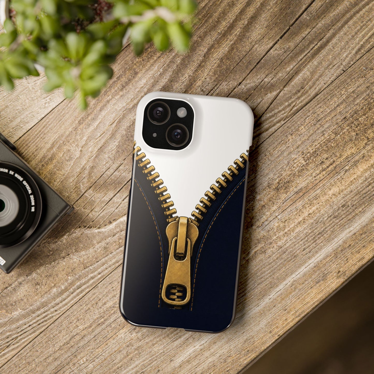 A close-up graphic of a metallic gold zipper opening up dark navy denim fabric - iphone 16 and 15 slim case