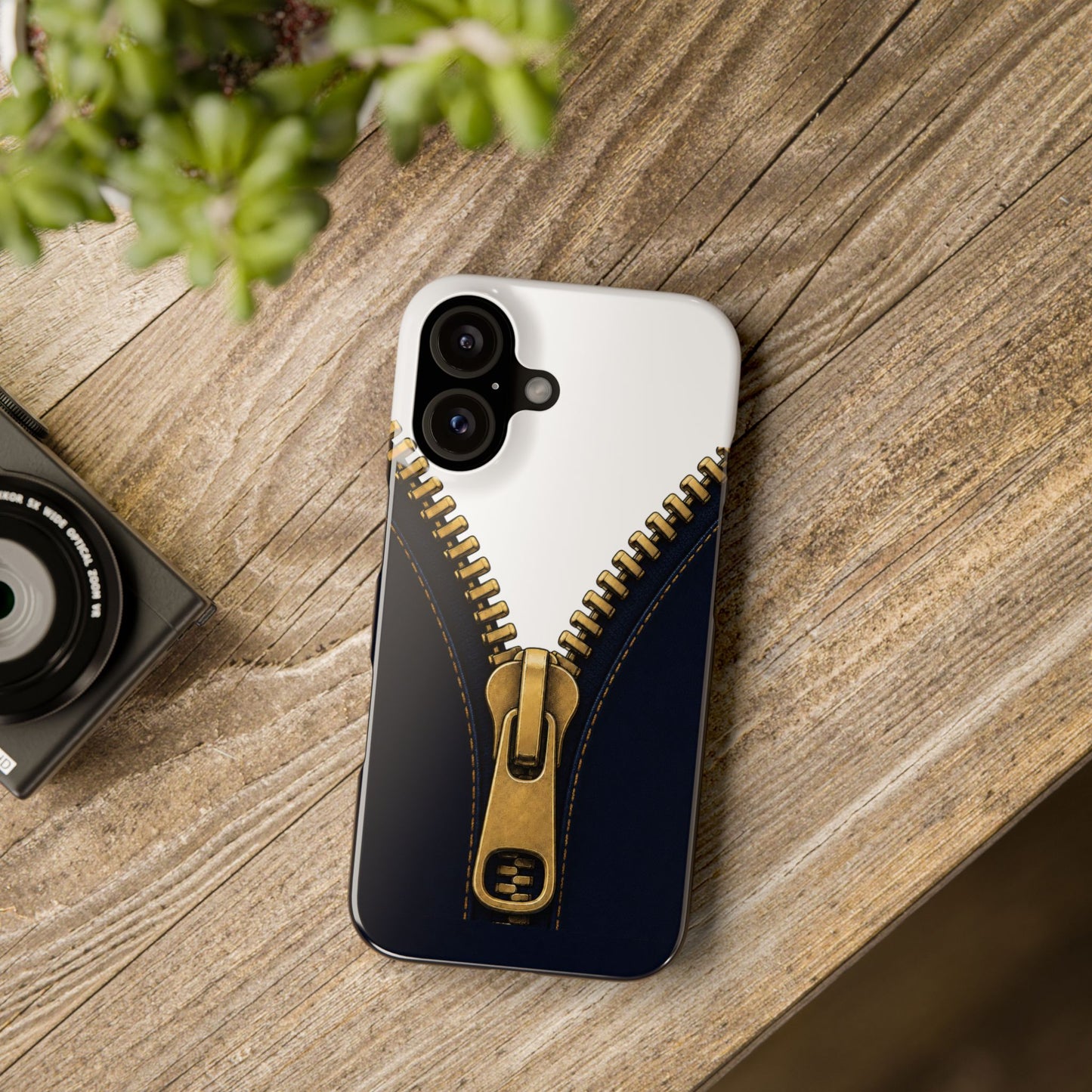 A close-up graphic of a metallic gold zipper opening up dark navy denim fabric - iphone 16 and 15 slim case